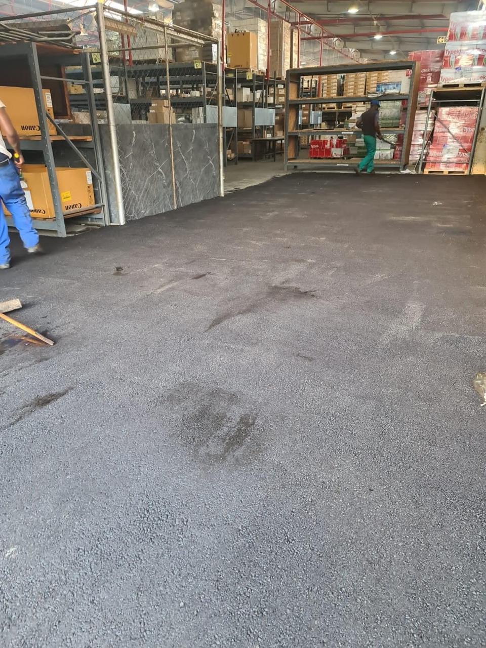 Asphalt floor surfacing inside commercial warehouse