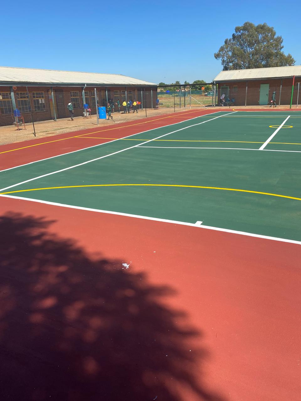 New tennis/netball court with line marking at school