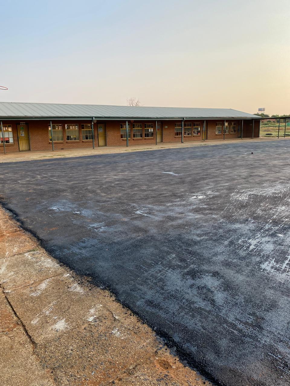 School block with newly surfaced asphalt courtyard