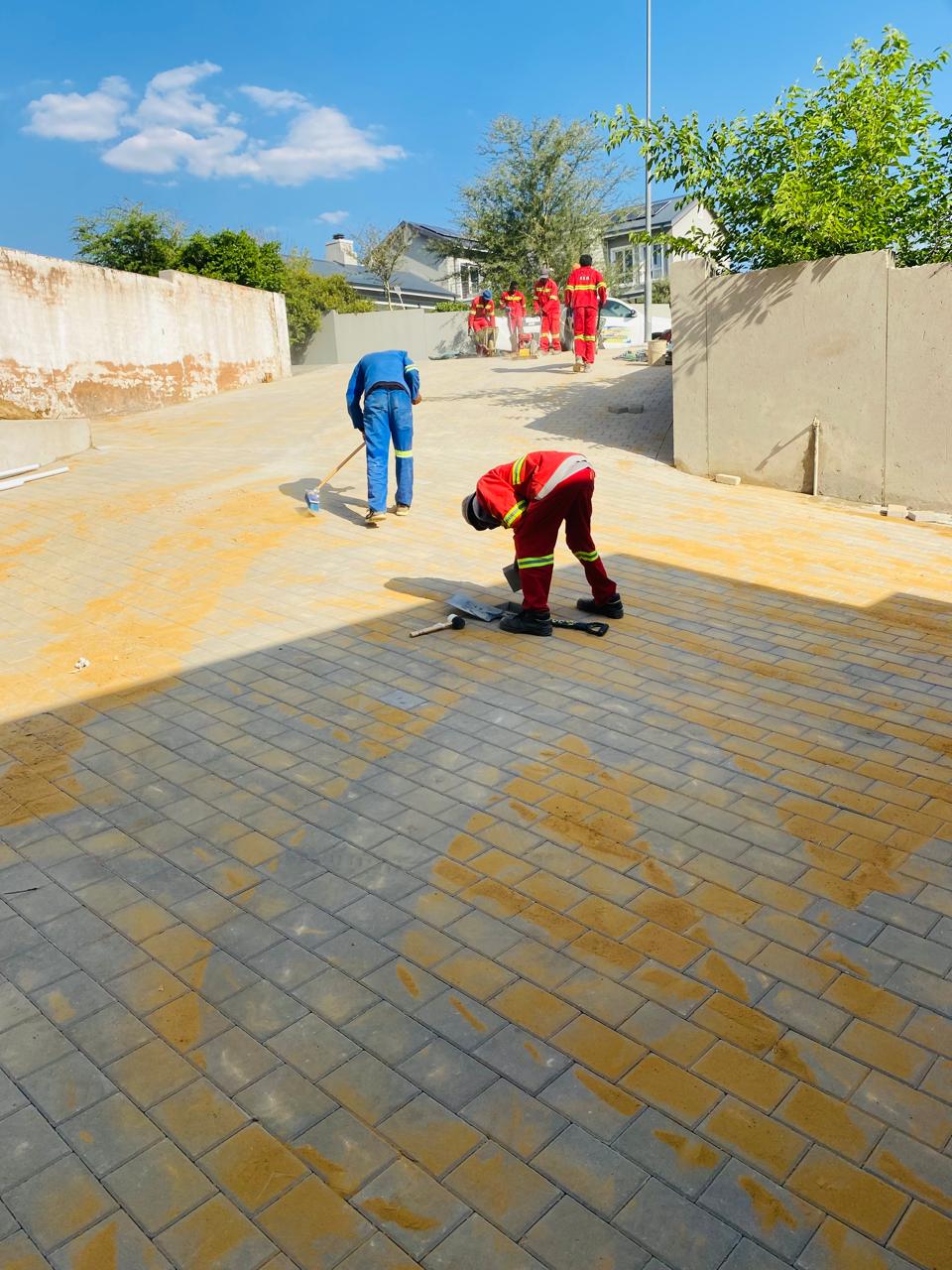 Final sand-sweeping and sealing of new paved driveway